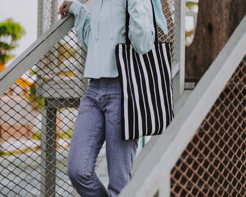 A person walking down stairs holding a bag