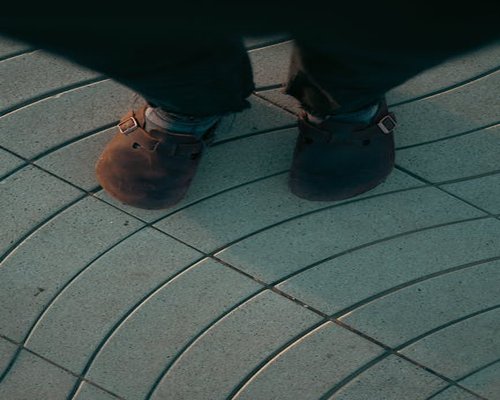 Detail of comfortable walking shoes on pavement